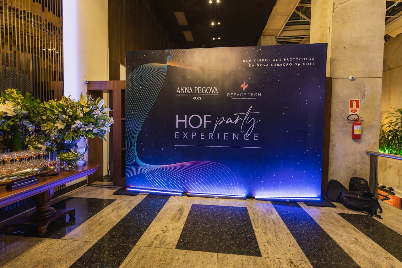 Elegant party entrance with decorated display and lush floral arrangements at HOF Party Experience.